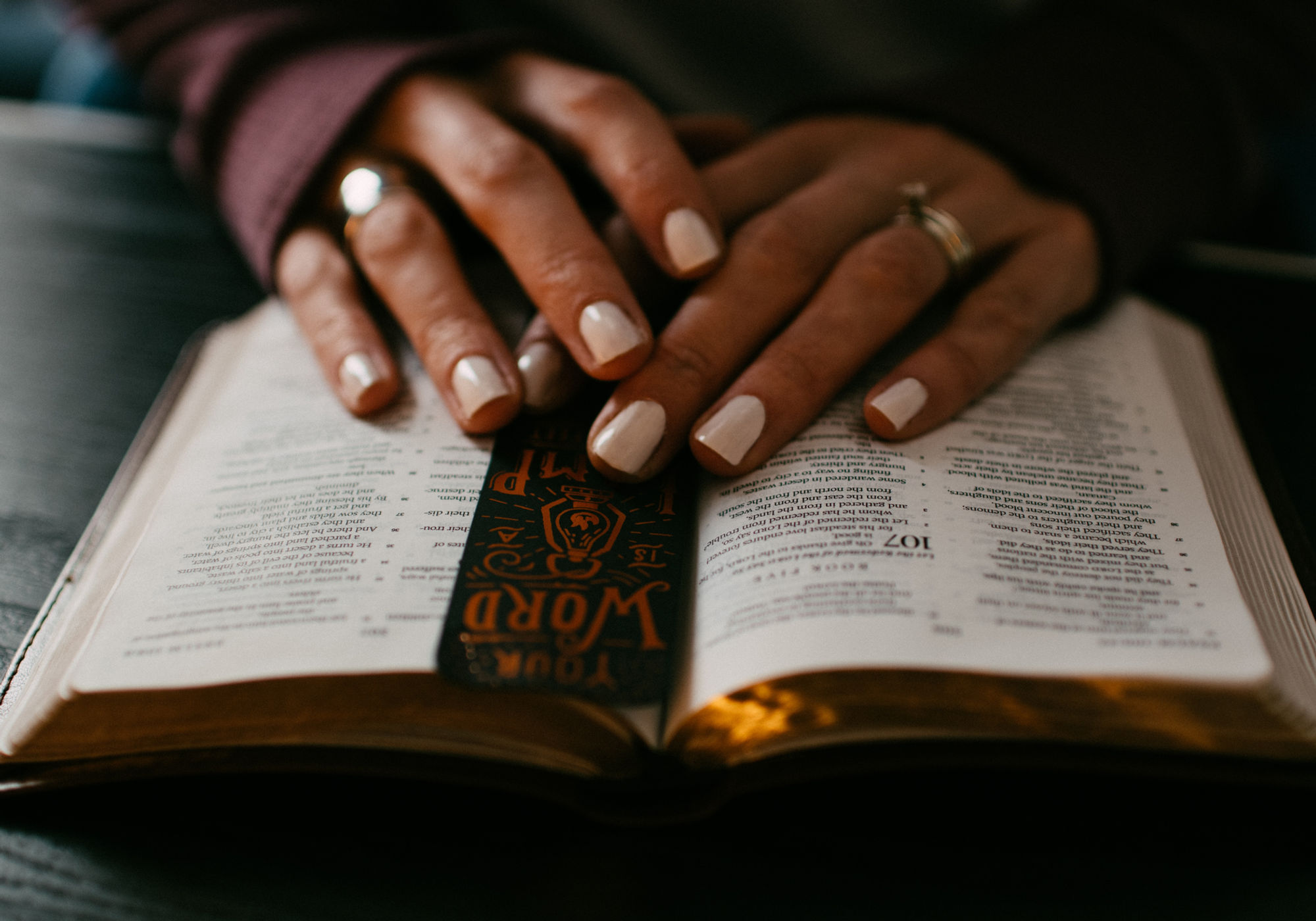 Hands resting on an open Bible